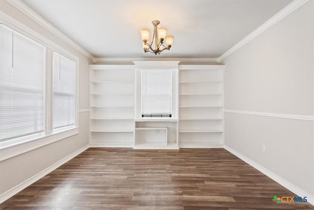 unfurnished dining area with a chandelier, ornamental molding, baseboards, and wood finished floors