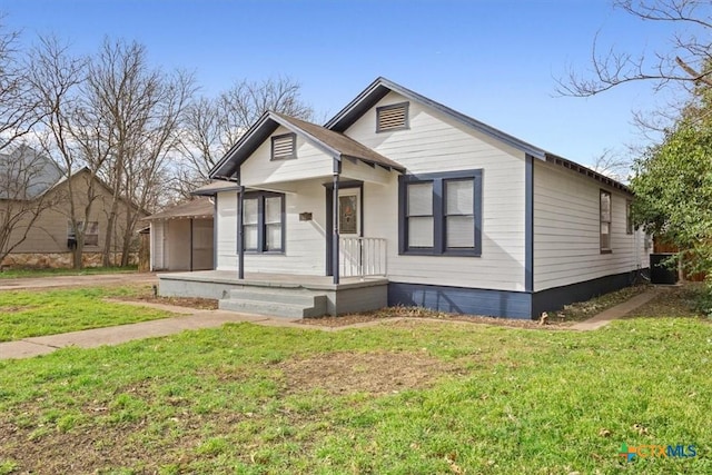 bungalow-style house with central air condition unit and a front yard