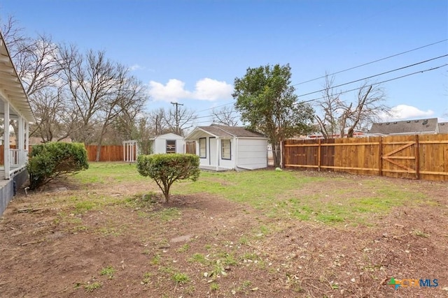 view of yard with a fenced backyard and an outdoor structure