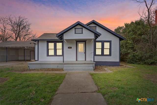 bungalow-style home with a front lawn and a porch