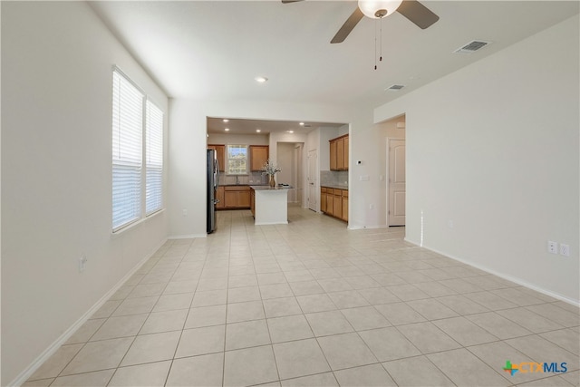 unfurnished living room with light tile patterned flooring and ceiling fan