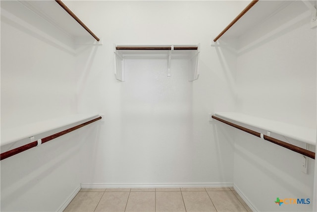 spacious closet with light tile patterned floors