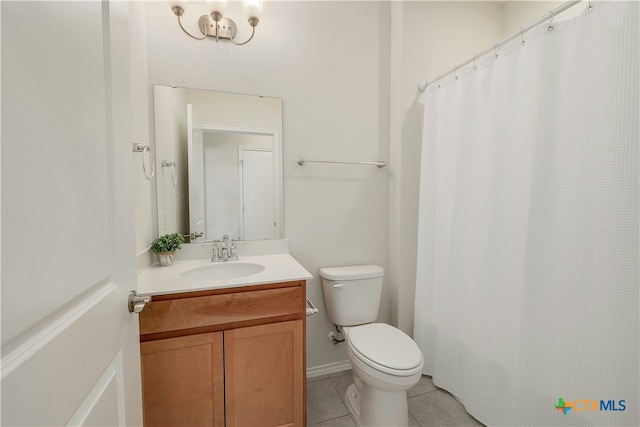 bathroom featuring vanity, tile patterned floors, and toilet