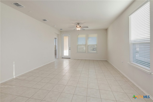 spare room with light tile patterned floors and ceiling fan