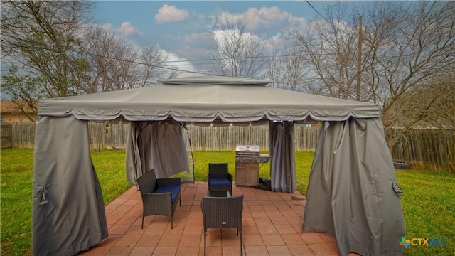 view of patio / terrace featuring a fenced backyard and a gazebo