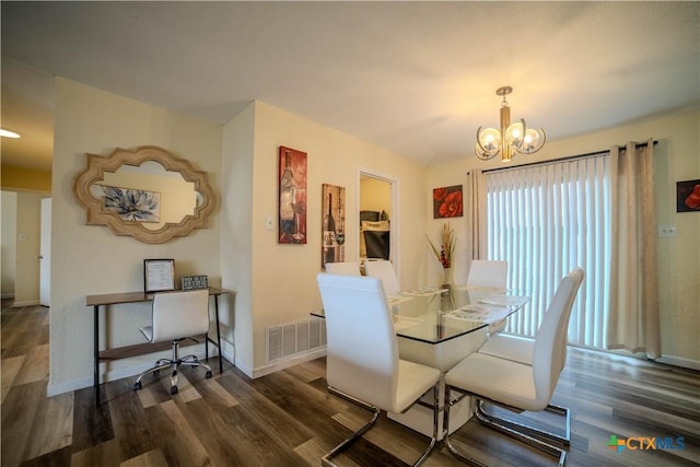 dining space with baseboards, dark wood-style flooring, visible vents, and a notable chandelier