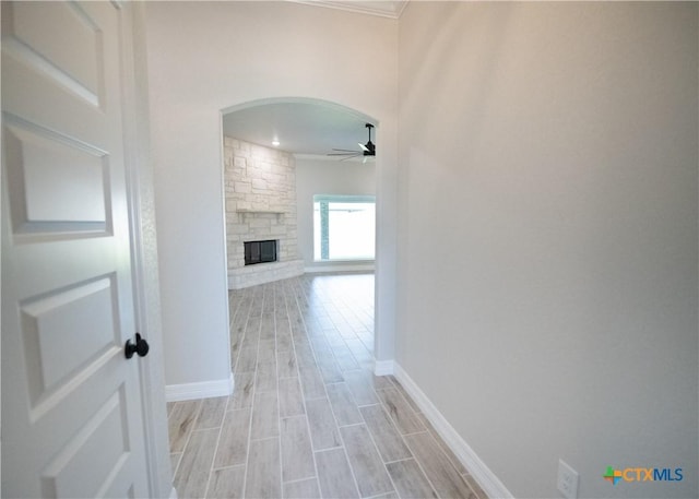 hallway with light hardwood / wood-style flooring and ornamental molding