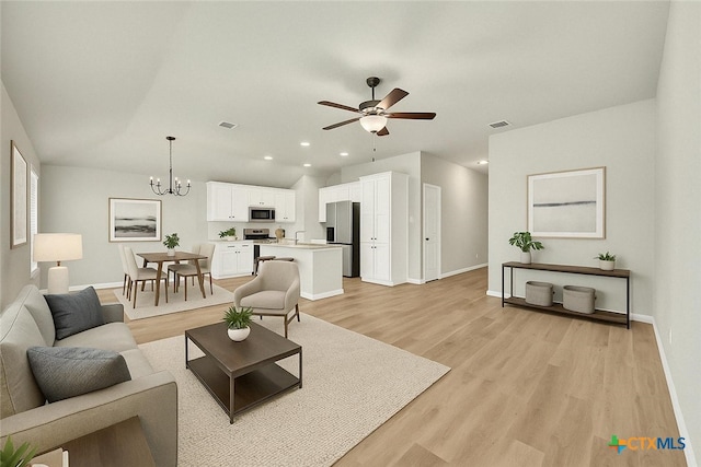604 Cypress Arbor, Seguin, TX 78155 - living room with baseboards, a ceiling fan, light wood finished floors, a chandelier, and recessed lighting