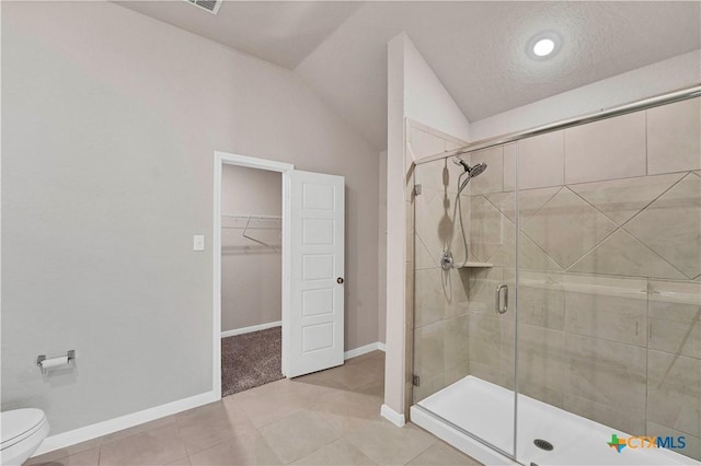604 Cypress Arbor, Seguin, TX 78155 - full bath featuring a shower stall, a spacious closet, toilet, tile patterned floors, and baseboards