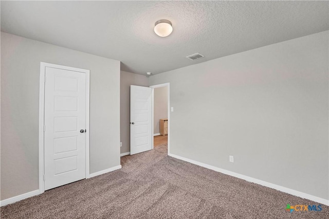 604 Cypress Arbor, Seguin, TX 78155 - unfurnished bedroom with carpet floors, baseboards, and a textured ceiling