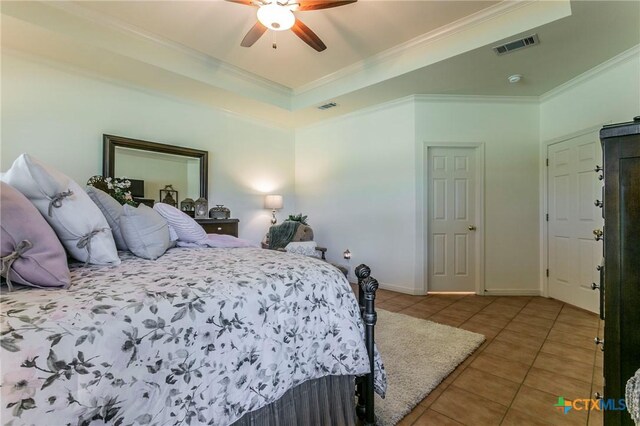 1320 Daisy Ln, Temple, TX 76502 - tiled bedroom with ornamental molding, a tray ceiling, and a ceiling fan
