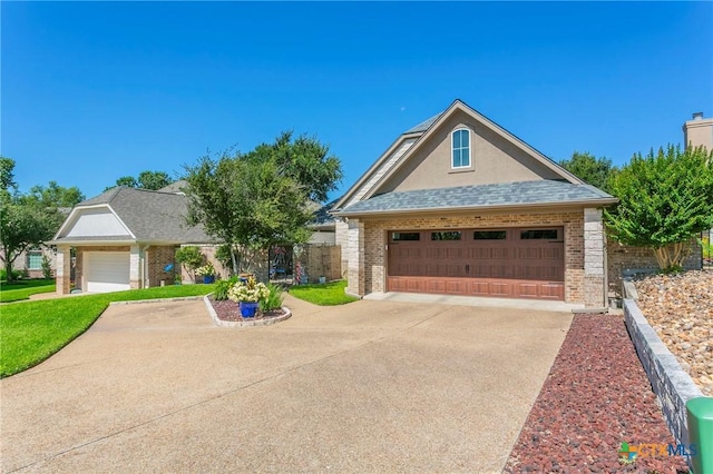 1320 Daisy Ln, Temple, TX 76502 - view of front facade with brick siding, a garage, and roof with shingles