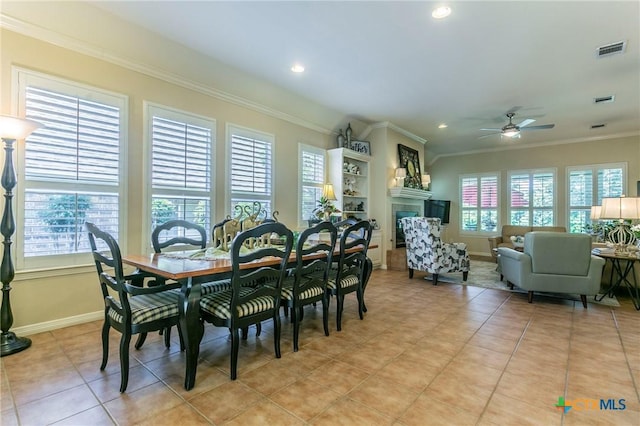 1320 Daisy Ln, Temple, TX 76502 - dining space featuring crown molding, a ceiling fan, light tile patterned flooring, recessed lighting, and a fireplace