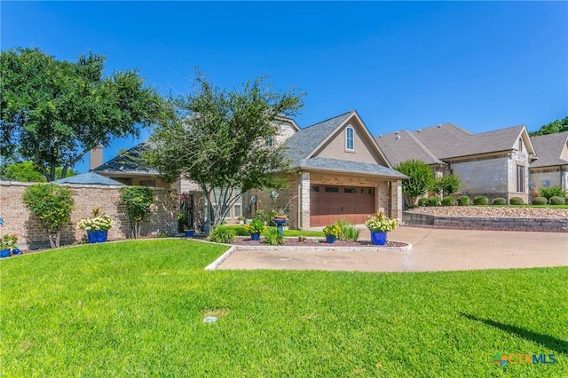 1320 Daisy Ln, Temple, TX 76502 - view of front of house featuring a front yard, concrete driveway, and an attached garage