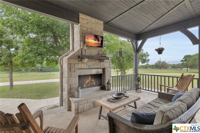 view of patio featuring an outdoor stone fireplace