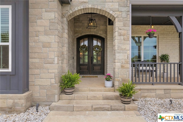 view of exterior entry featuring french doors