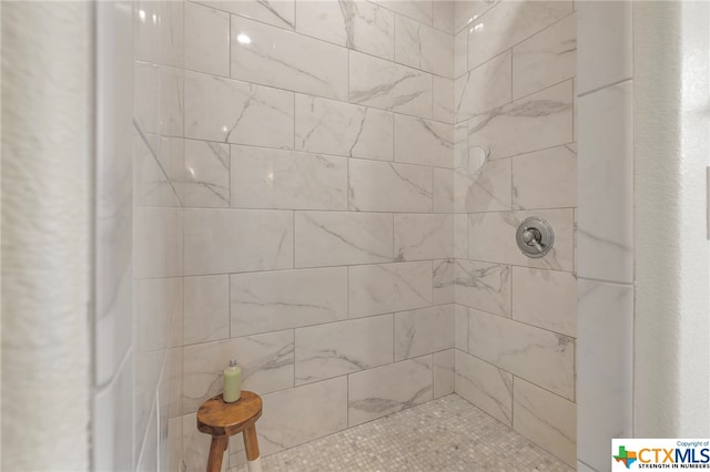 bathroom with tiled shower