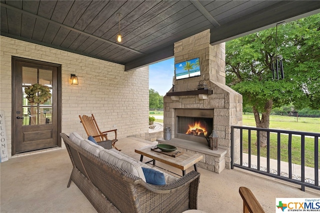 view of patio / terrace with an outdoor stone fireplace