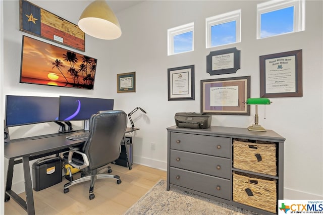 office space with light hardwood / wood-style floors