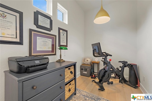 workout room featuring light wood-type flooring