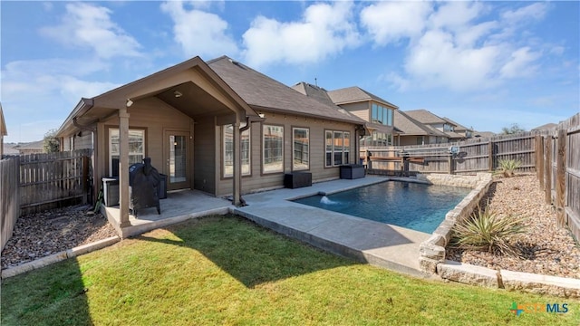 back of property featuring a fenced backyard, a fenced in pool, a patio area, and a lawn
