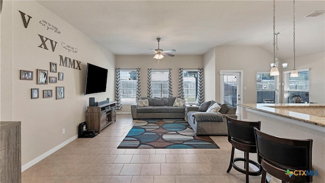 living room featuring light tile patterned flooring, ceiling fan, baseboards, and visible vents