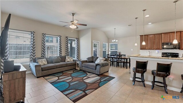 living room featuring ceiling fan with notable chandelier, light tile patterned floors, recessed lighting, lofted ceiling, and baseboards