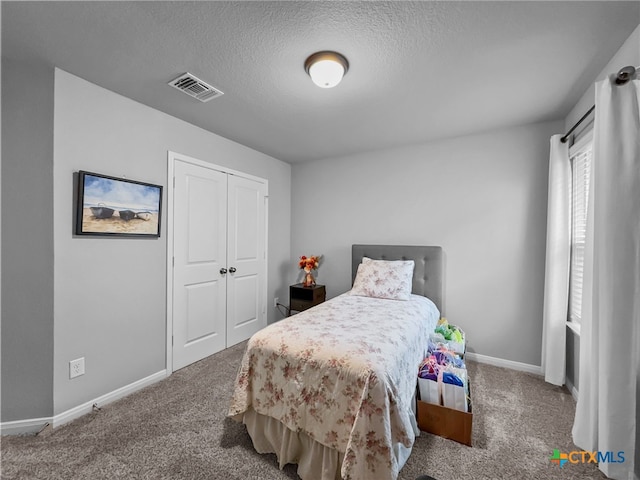 1525 Dryden Ave, Copperas Cove, TX 76522 - carpeted bedroom with baseboards, a textured ceiling, and a closet
