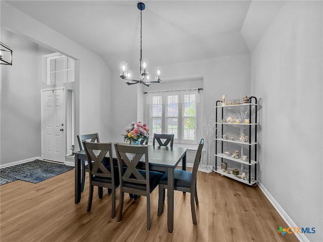 1525 Dryden Ave, Copperas Cove, TX 76522 - dining area featuring light wood-style floors, a chandelier, baseboards, and vaulted ceiling
