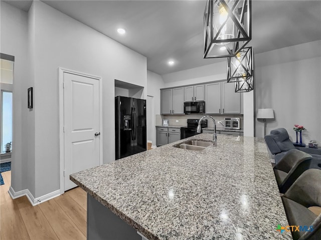 1525 Dryden Ave, Copperas Cove, TX 76522 - kitchen with black appliances, a sink, gray cabinets, light stone countertops, and recessed lighting