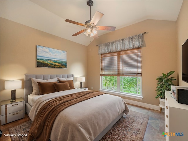 bedroom featuring ceiling fan and lofted ceiling