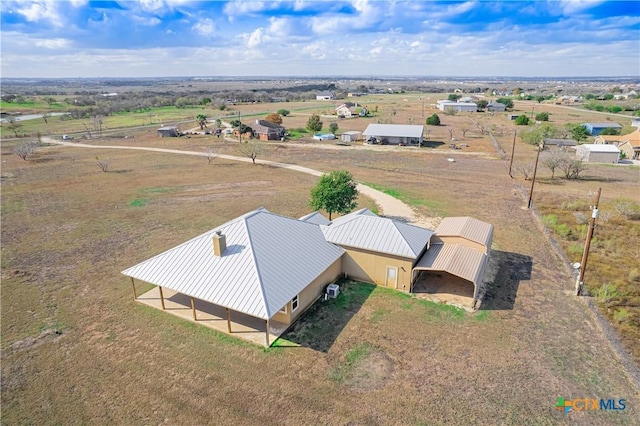 birds eye view of property with a rural view