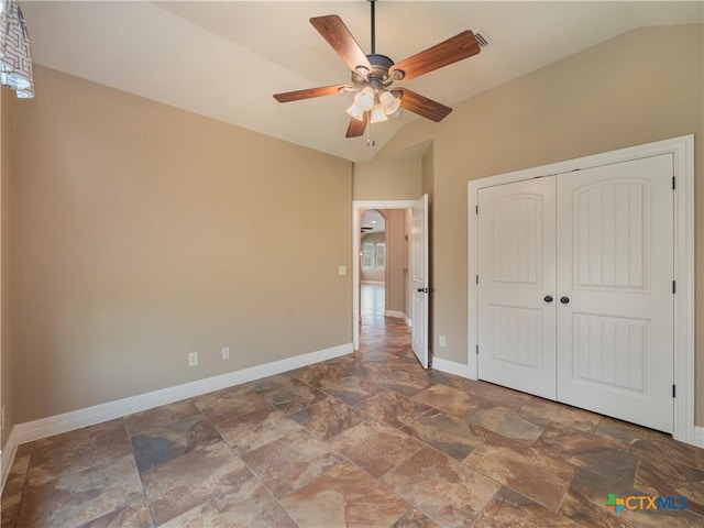 unfurnished bedroom featuring a closet, ceiling fan, and lofted ceiling