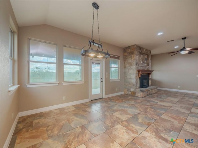 unfurnished living room featuring ceiling fan, lofted ceiling, and a fireplace