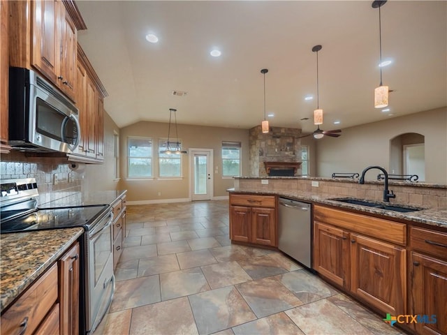 kitchen featuring ceiling fan, sink, stainless steel appliances, tasteful backsplash, and pendant lighting