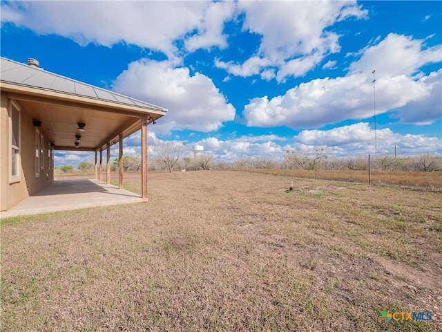 view of yard featuring a rural view and a patio