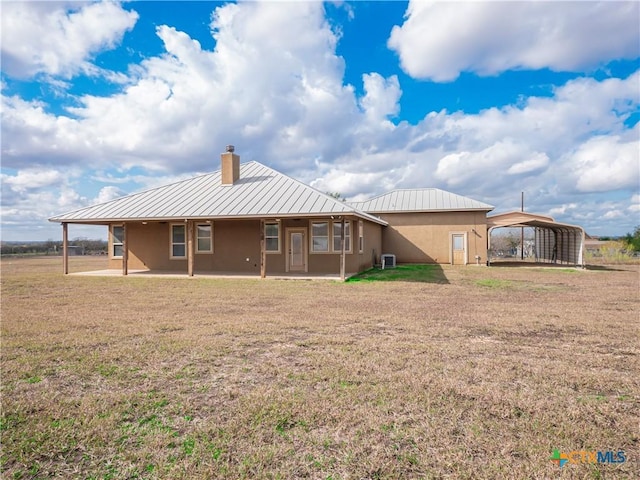 back of house with a carport