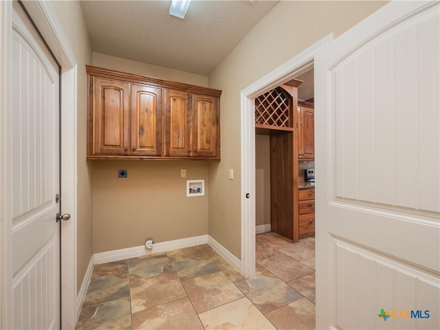 laundry room featuring hookup for an electric dryer, cabinets, and washer hookup