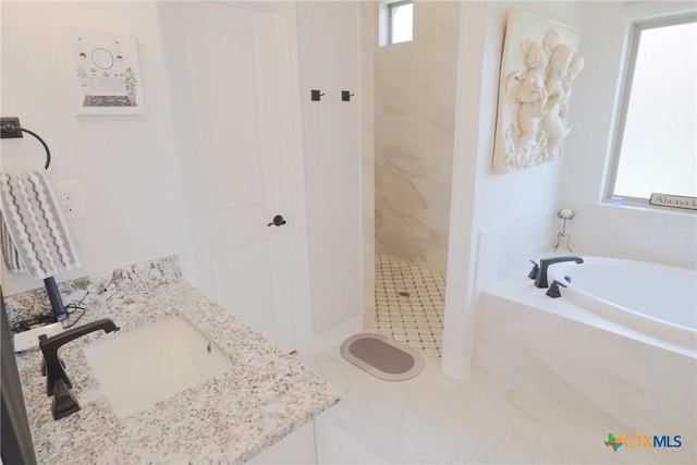 full bathroom featuring a garden tub, vanity, and a shower stall