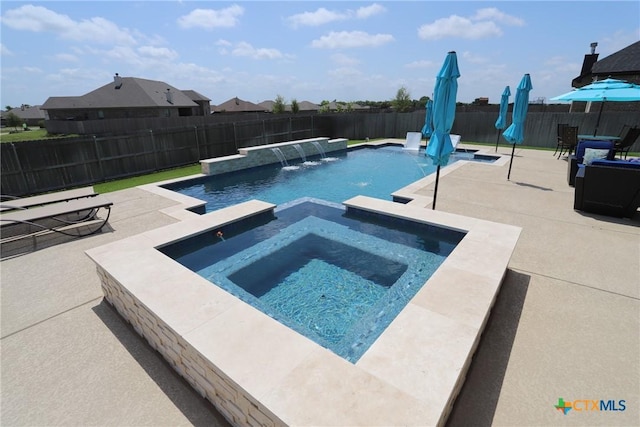 view of pool featuring a fenced backyard, a pool with connected hot tub, and a patio