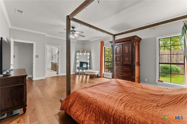 2717 Canyon Oaks Ct, Temple, TX 76502 - bedroom featuring light wood-style floors, multiple windows, ornamental molding, ensuite bath, and a ceiling fan