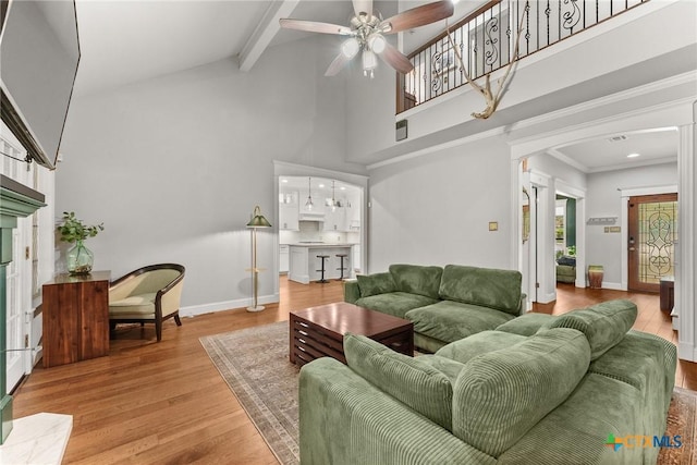 2717 Canyon Oaks Ct, Temple, TX 76502 - living room with ceiling fan, a high ceiling, wood finished floors, arched walkways, and beamed ceiling