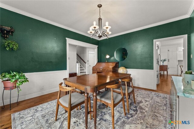 2717 Canyon Oaks Ct, Temple, TX 76502 - dining area with light wood-style floors, a chandelier, ornamental molding, and stairway