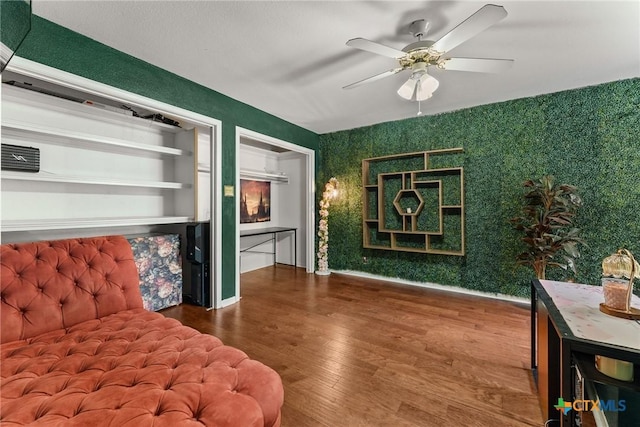 2717 Canyon Oaks Ct, Temple, TX 76502 - living room with wood finished floors, a ceiling fan, and wallpapered walls