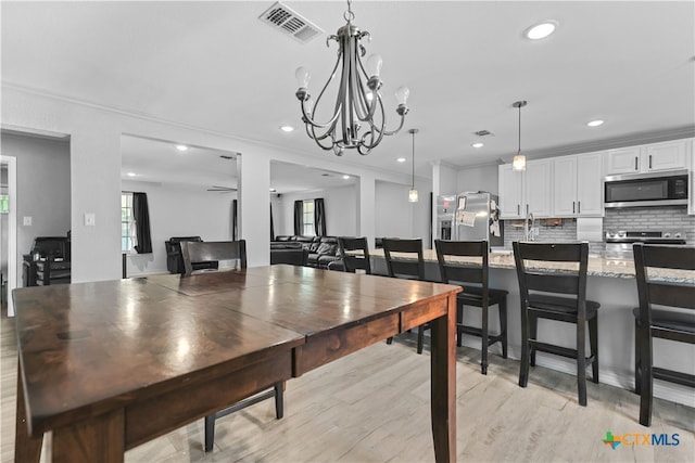 120 Mighty Oak Ln, Killeen, TX 76542 - dining room featuring light wood-style floors, a chandelier, recessed lighting, and ornamental molding