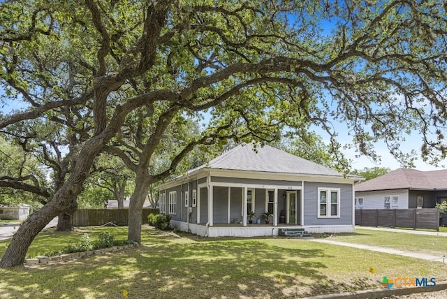 212 Whitfield St, Yoakum, TX 77995 - rear view of house with covered porch and roof with shingles