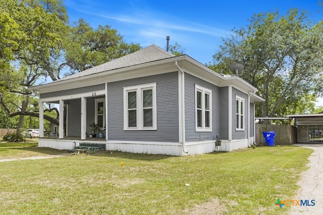 212 Whitfield St, Yoakum, TX 77995 - view of property exterior featuring a porch, a lawn, and driveway