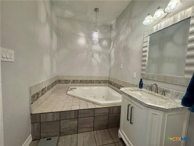 212 Whitfield St, Yoakum, TX 77995 - bathroom featuring vanity, a whirlpool tub, and tile patterned floors