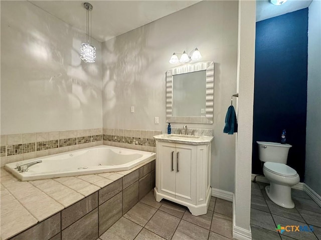212 Whitfield St, Yoakum, TX 77995 - bathroom with tile patterned floors, a tub with jets, toilet, and vanity