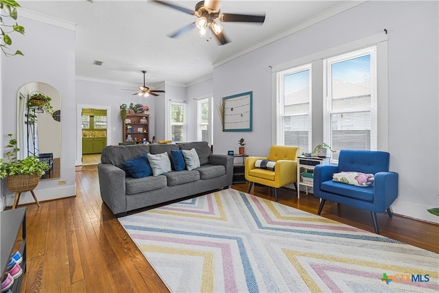 212 Whitfield St, Yoakum, TX 77995 - living area featuring wood-type flooring, ceiling fan, ornamental molding, and baseboards